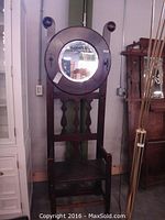Front view of oak hall stand showing mirror, hooks and seat