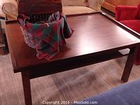 Front angled view showing dark reddish-brown wooden coffee table with flat tabletop and basket on top.
