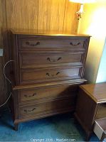 Front view of full highboy showing five drawers and brass handles