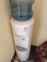 Full view of the Crystal Mountain water cooler with water jug on top, showing the spouts and drip tray.