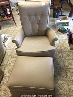 Front view of taupe rocker swivel chair and matching ottoman