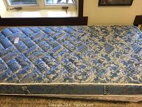 Top view of single bed mattress showing blue and gold quilted pattern