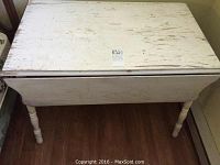 Full view of top surface showing worn white paint and extension leaves folded down