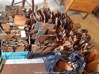 Top view of multiple stacked crates filled with assorted old wood shingles showing varied sizes and natural aged wood textures.