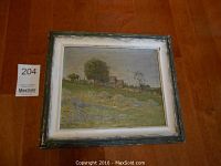 Framed oil on board painting showing a rural barn scene with trees and grassy area, displayed on hardwood floor.