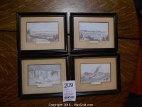 Four framed vintage landscape prints arranged on a wooden surface, showing all artworks and their matching black frames with cream mats.