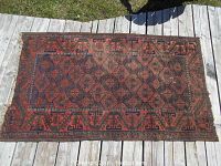 Full view of rug laid flat on wooden deck