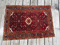 Full view of rug on wooden floor showing overall pattern and size