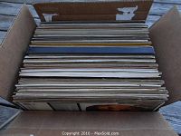 Box filled with approximately 60 vintage classical vinyl records in sleeves.