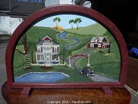 Front view of the hand painted scene showing the full country setting including farmhouse, barn, pond, and pathway in a red wooden frame with arched top.