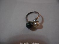 Top view showing ring with dark and light pearl-like stones