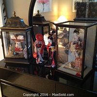 Overall view of all geisha dolls and display cases on dresser surface