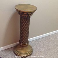 Photo of a tall brown wooden plant stand with pineapple pattern column and round top and base.