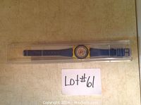 Child's Swatch Expo 86 watch in original clear plastic case displayed top-down.