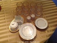 Photo of 8 gold-rimmed highball glasses, Nikko China cream and sugar set with plate, salt and pepper shakers, and dinner and side plates
