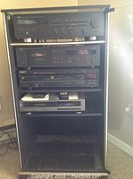 Yamaha RX360 stereo receiver, Yamaha KX150 cassette recorder, Sony 5 disc CD changer stacked in stereo cabinet