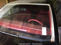 Front windshield view of red velvet interior and steering wheel