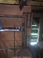 Photo showing wooden Oakville Journal Record sign with days of the week and part of black rod iron railing.