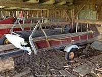 Side view in barn showing entire wood-sided bed and metal frame