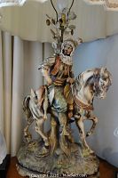 Close-up of the cold painted bisque lamp depicting an Arabian sheik on a horse, showing detailed sculpting and painted features.