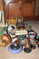 Overview of assorted decorative items including boxes, plates, bowl and domes