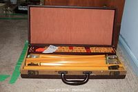 Open brown hinged storage case showing interior and mah jong tile racks