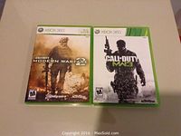 Two Xbox 360 games: Call of Duty Modern Warfare and Call of Duty MW3, both in original cases.