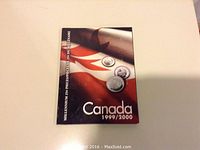 Front cover of the booklet showing title and Canadian coins on a flag background.