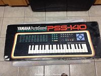 Photo of Yamaha Portasound PSS-140 cardboard packaging box showing model and branding.