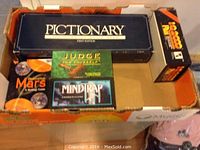 Box with Pictionary, Judge For Yourself, Mind Trap, Destination: Mars, and Pictionary board games