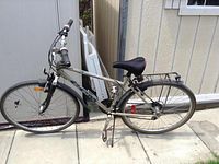 Side view of the silver CCM City Sport bicycle showing frame, wheels, saddle, fenders and rear rack