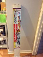 Front view of the original packaging showing product name, brand/logo, and images explaining the use of the multi-purpose metal sports rack