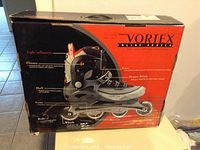 Photo of the original Vortex inline skates box, showing product features such as light reflectors, closure, shell, frame, brake, wheels, liner, and power strap.