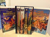 Five Land Before Time VHS movies in cases showing colorful animation cover art, with titles visible.