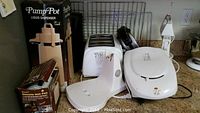 Photo showing toaster, waffle iron, liquid dispenser, and coffee maker on a countertop, all untested kitchen appliances.
