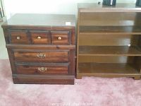 Photo of a wooden 3-drawer dresser and wooden bookcase placed side by side on a pink carpeted floor.