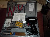 Overall view of soldering kit in molded carrying case including soldering gun, pliers, multiple soldering tips, and instructions.