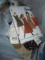 Photo showing a close-up of a sewing pattern packet with illustrations of dress designs.