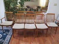 Overview of all eight chairs arranged in two rows showing full set and condition