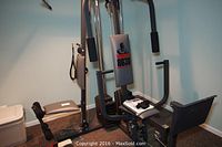 Full side angle photo showing assembled Weider 8630 home gym machine with padded seat and weight stack.
