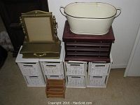 Photo showing four white wooden organizers with two small white wicker baskets each, a medium wood jewelry box, a gold-toned jewelry box with mirror, a small wood organizer, and a cream-colored decorative metal basket on top.