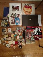 Collection laid out showing all items: matchbooks, currency, comic, brochures, and books including Playboy's Little Annie Fanny.