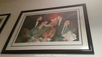 Frontal view of the entire framed serigraph hanging on wall