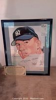 Full view of framed lithograph with certificate of authenticity card in front