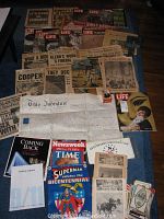 Overview shot of magazines, newspapers, indenture document and assorted ephemera spread on floor
