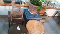 Blue painted vintage child's potty seat and other furniture items including ottomans and chairs arranged near windowsill