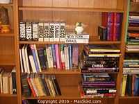 Bookshelf shelf with Cubeixx Wonders of the World boxed sets and various travel and fiction hardcover books