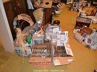 Wide view of lot showing canning jars, baskets, wreath, gift basket, vintage washboard, and various household items.