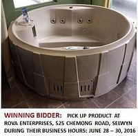 Round cobblestone-colored spa unit with built-in jets and control panel