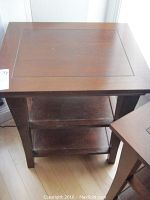 Top view of the solid wood cherry finish end table showing the surface and part of the two shelves below.